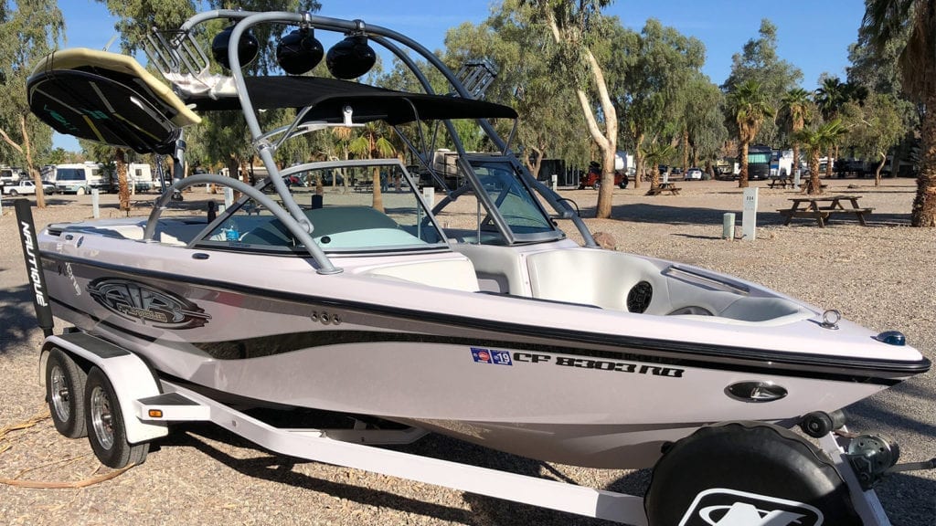 2004 Super Air Nautique 210 Team Edition with boards on rack, wetsounds speakers, on trailer