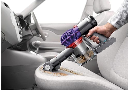 Dyson V7 car vacuum cleaning seat in car