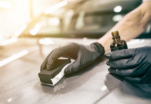Man applying best ceramic car coating on car hood