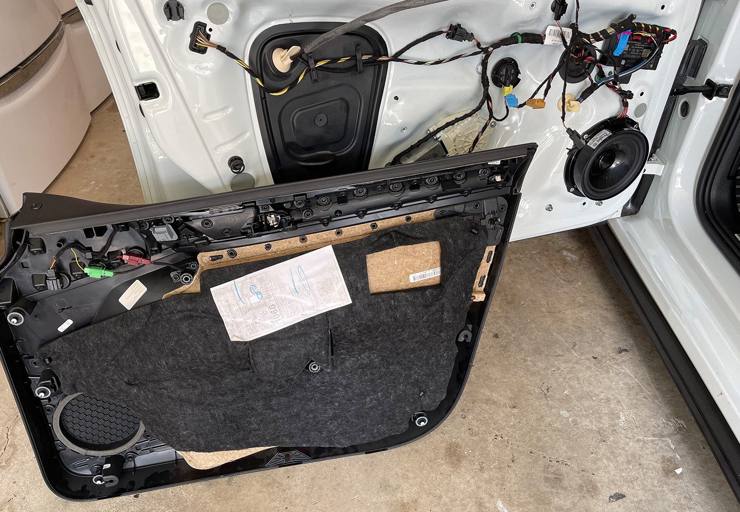 Picture of the front driver side door panel removed before removing the OEM Fender speaker on a 2018 GTI MK7.5