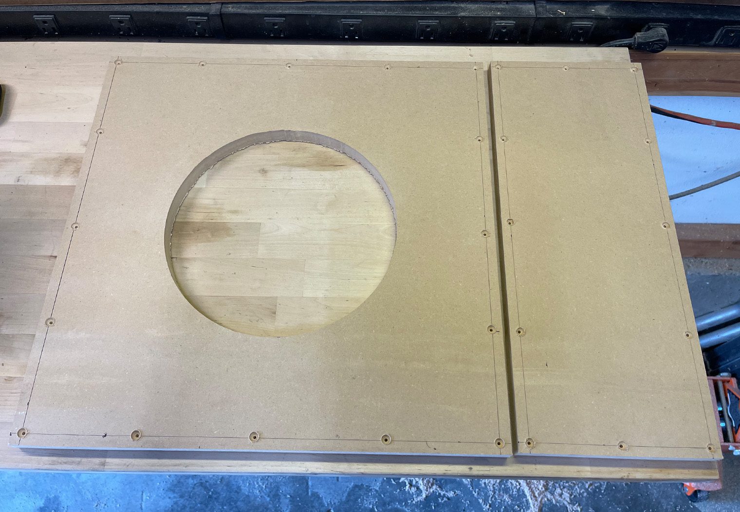 Picture of the subwoofer enclosure panels predrilled before assembly