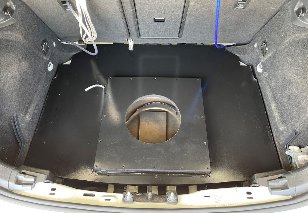 Picture of a completed custom subwoofer enclosure and amp rack for 2018 VW GTI MK7.5 with Fender system