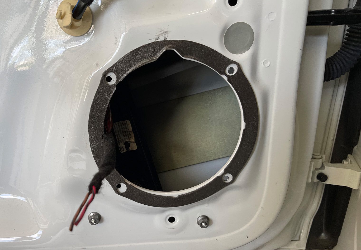 Picture of the driver front door of VW GTI MK7.5 with sealing material before installing upgraded Sony component speakers