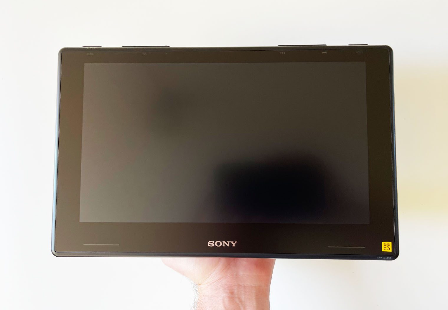 Holding the Sony XAV-9500ES 10inch screen in hand to showcase the size and look