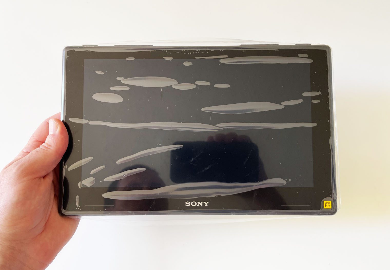Holding the Sony XAV-9500ES screen to showcase how large it is