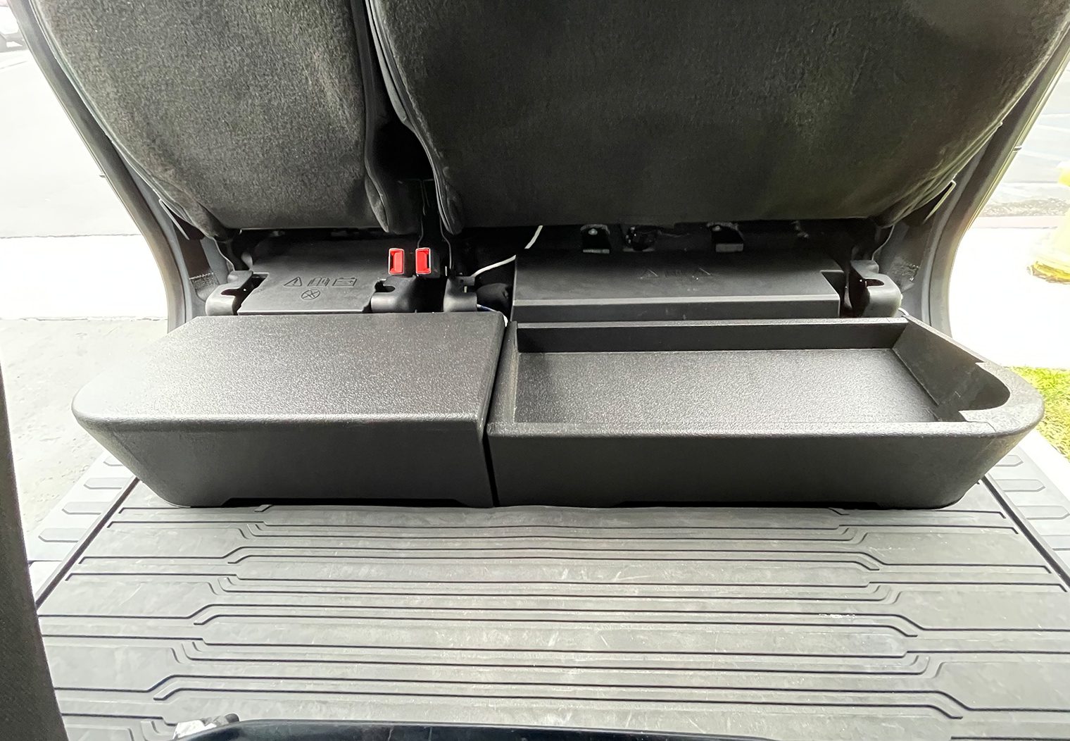 View of the custom enclosure installed with the seats up from the front of the truck