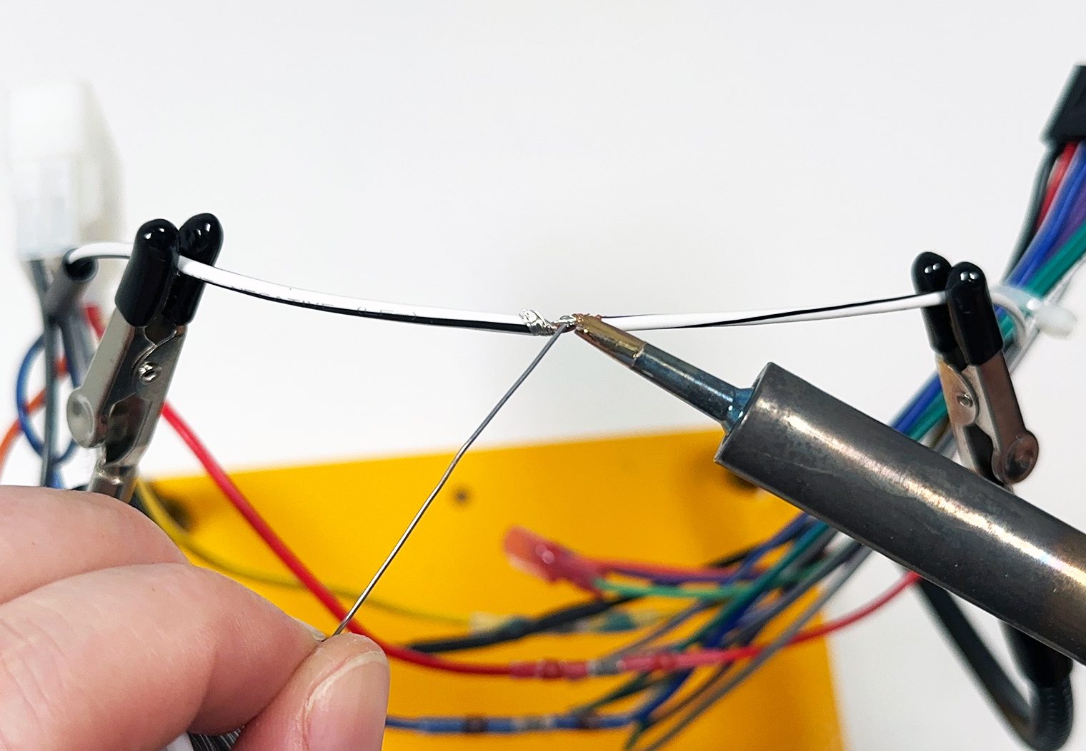 Soldering two wires together with solder iron
