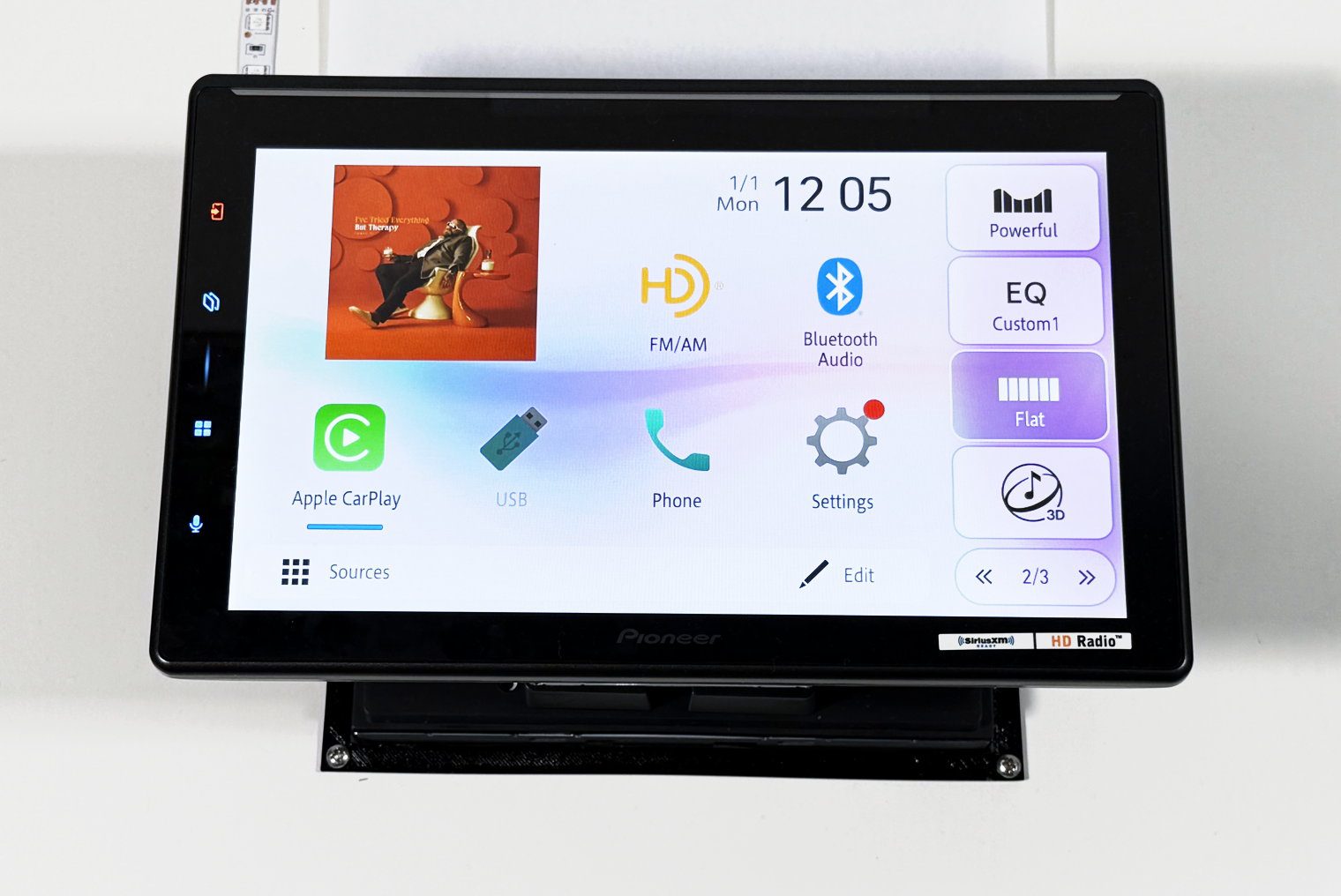 Pioneer SPHERA DMH-WT8000NEX powered on at the test bench, home screen up, with a coaxial speaker on each side