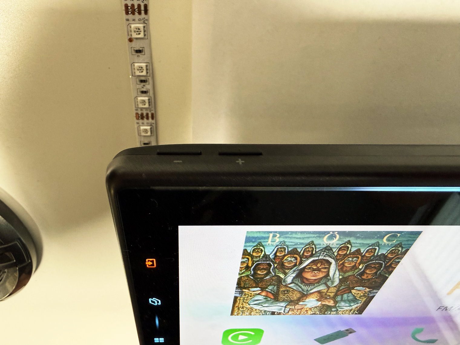 Top-left edge of the Pioneer DMH-WT8000NEX monitor with the physical volume + and − buttons