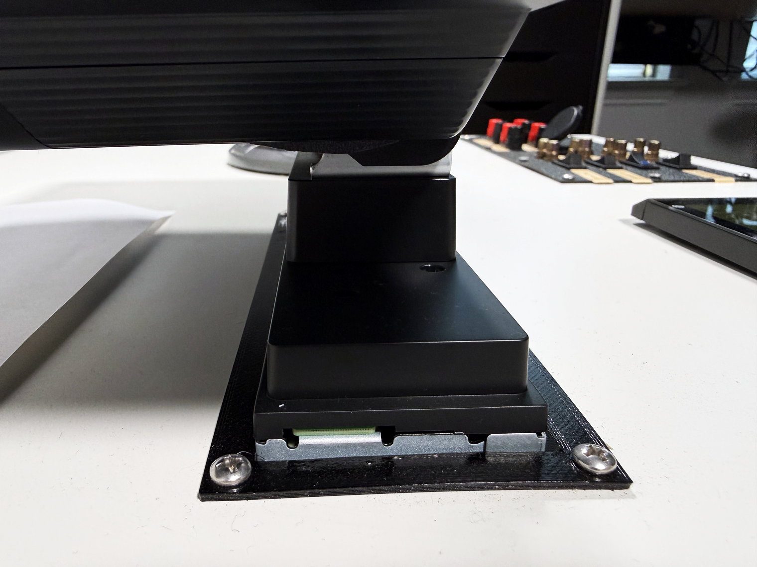 Pioneer DMH-WT8000NEX mount rising from the single-DIN chassis face to the underside of the floating screen on my bench