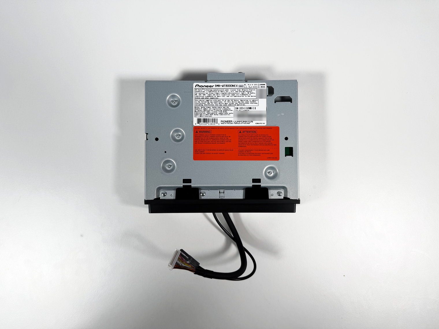 Top of the Pioneer DMH-WT8000NEX single-DIN chassis with the model label and red warning sticker