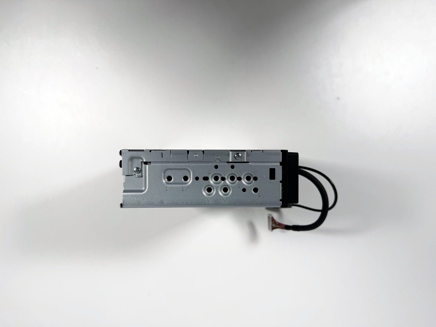 Side of the Pioneer DMH-WT8000NEX single-DIN chassis showing the screw holes for the mounting brackets