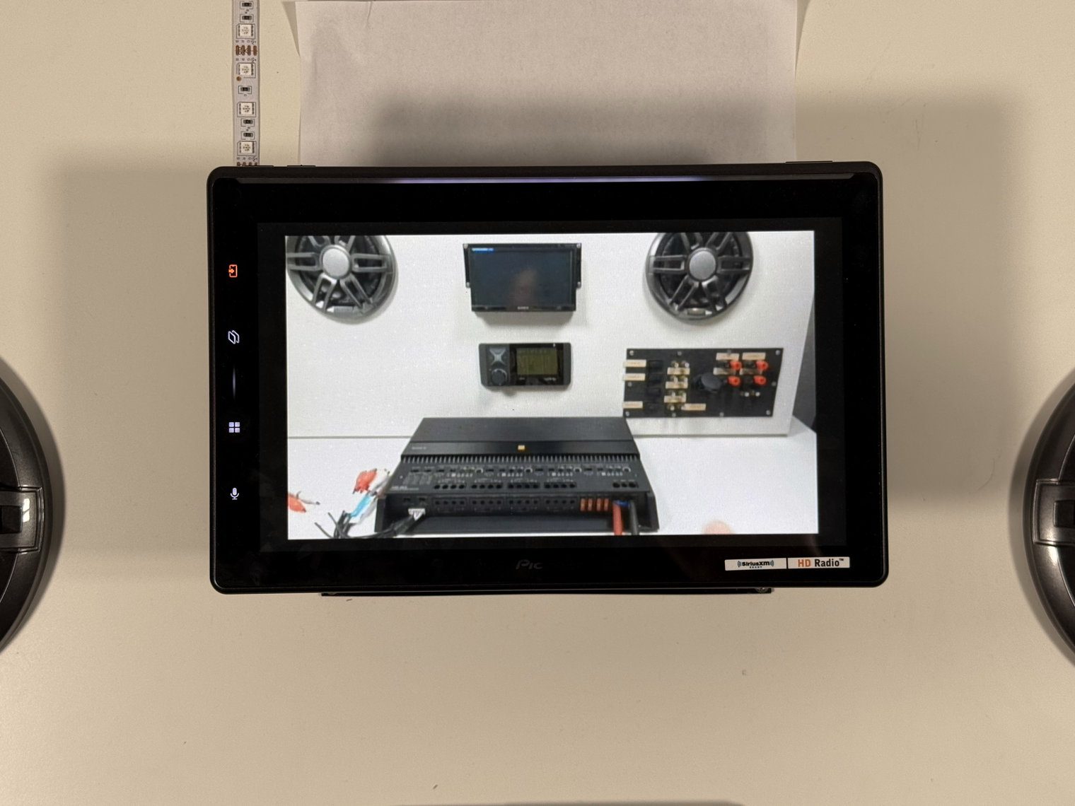 Fire TV video on the Pioneer DMH-WT8000NEX over composite, showing a speaker and amplifier test wall