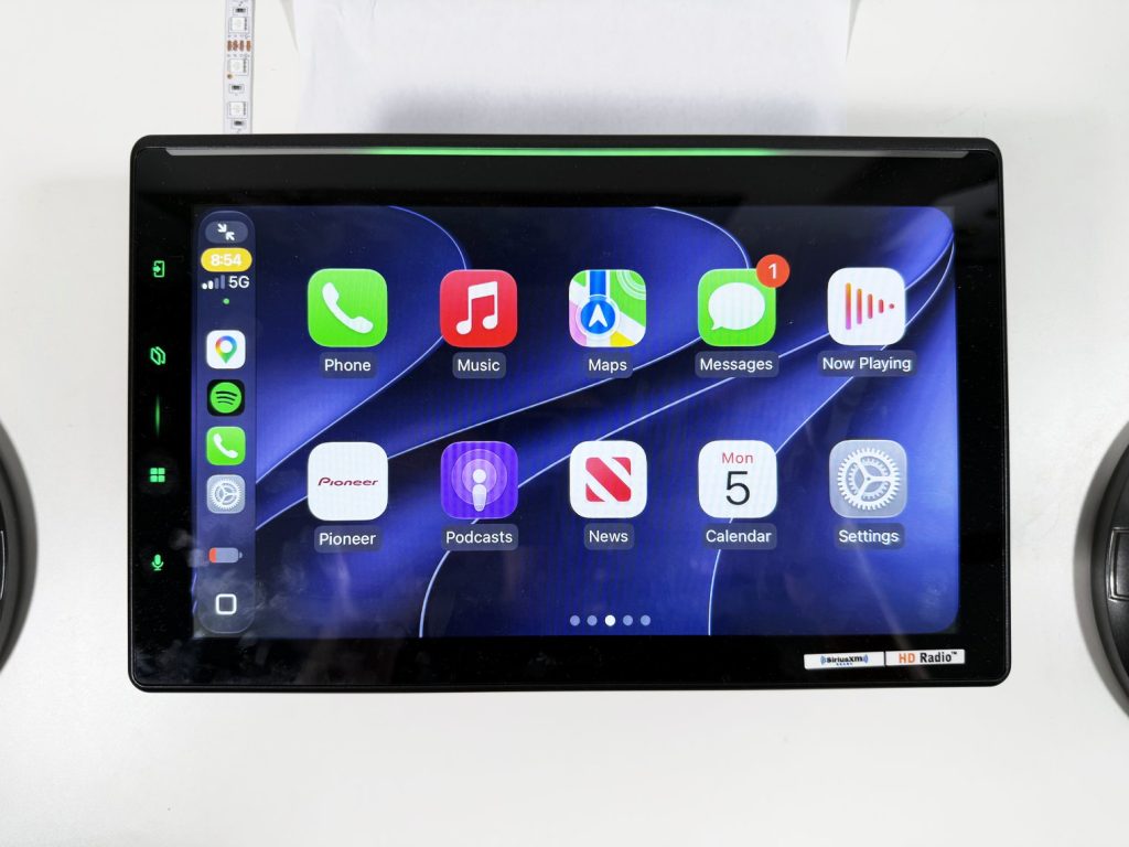 Pioneer DMH-WT8000NEX showing the Apple CarPlay home screen across its 10.1-inch display with the Luminous Bar lit green