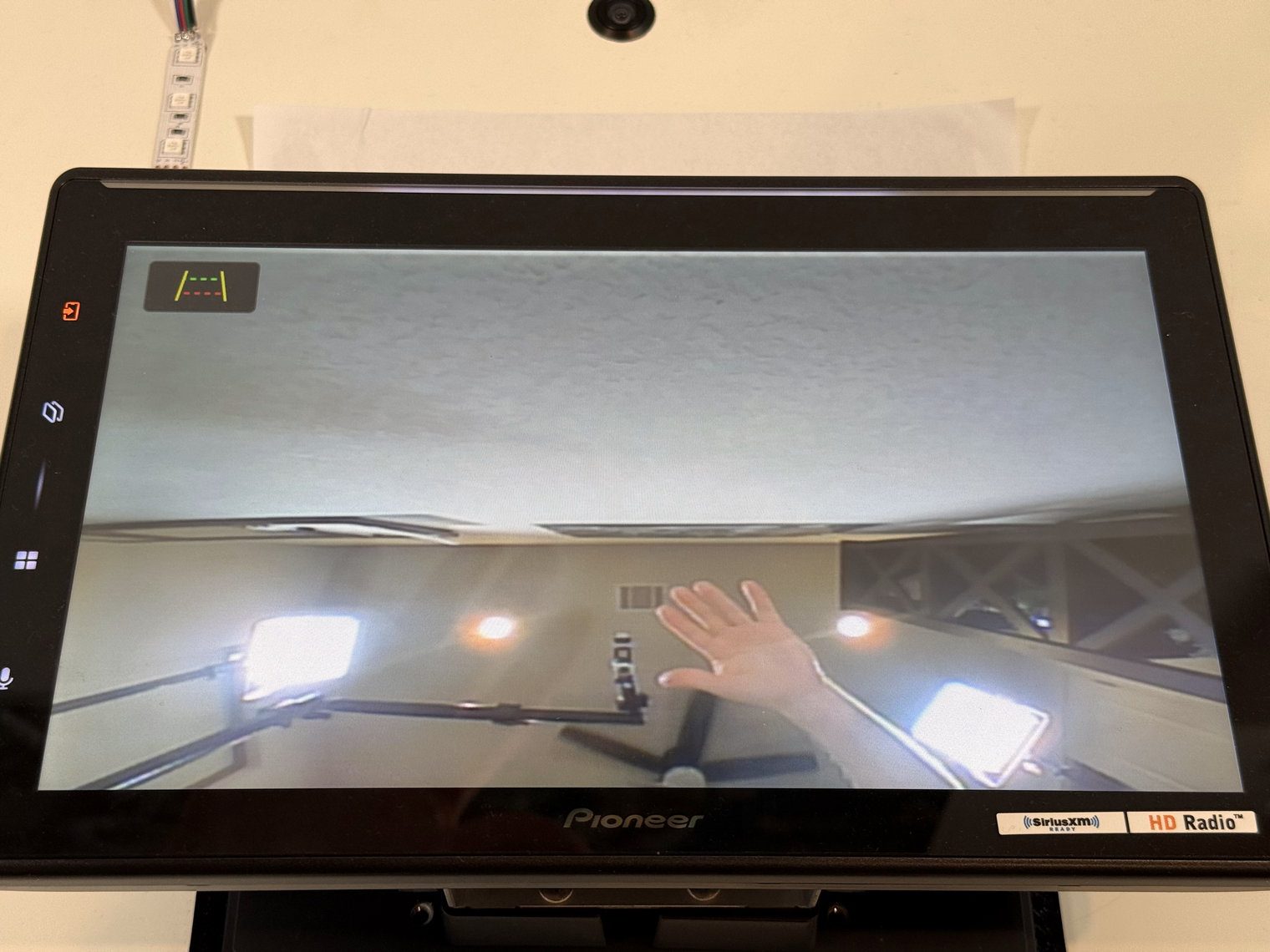 Pioneer DMH-WT8000NEX showing the live backup camera feed on the bench with the parking guidelines off