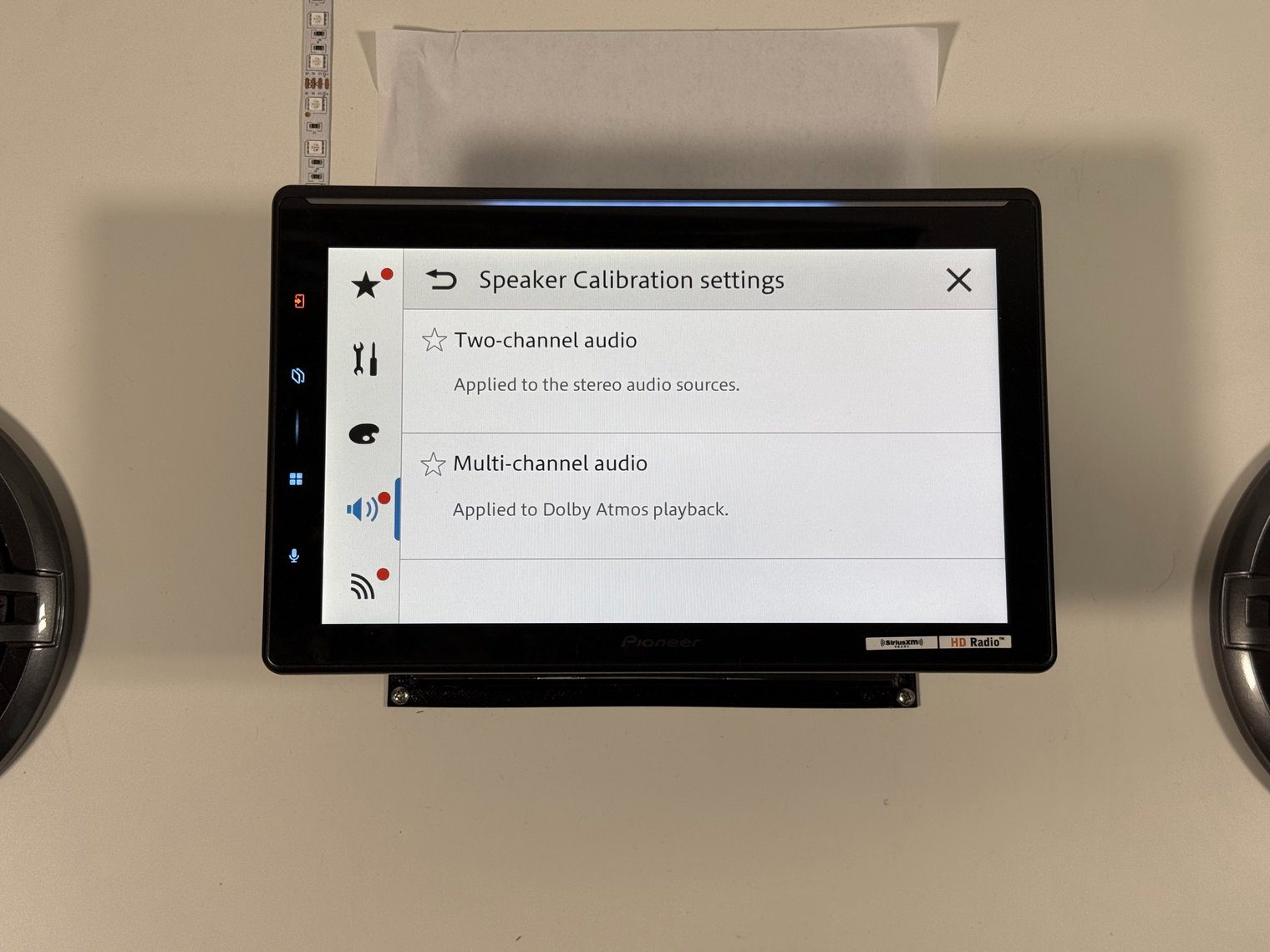 Pioneer DMH-WT8000NEX Speaker Calibration settings menu with Two-channel audio and Multi-channel audio options